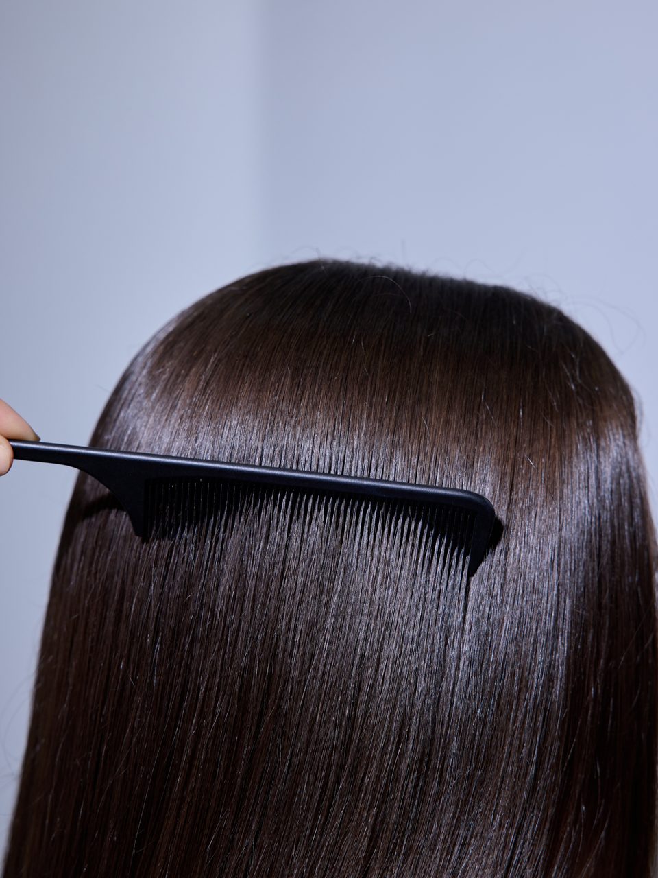 Smooth brunette hair combed at Selmur